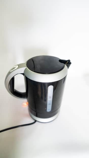 A close-up shot of a stainless steel electric kettle with a digital display showing the water temperature in a Nigerian kitchen. The kettle is sitting on a countertop with various kitchen appliances in the background.