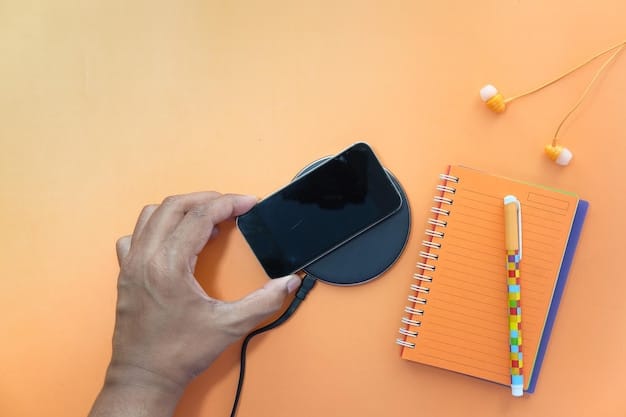 A close-up shot of a power bank charging a smartphone on a desk with a fan blowing in the background, showcasing the typical environment where power banks are used in Nigeria.