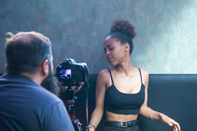 A Nigerian film director is on set, coaching a young actress. The set is modern and well-equipped, demonstrating the increasing professionalism in Nollywood. In the background, crew members are operating cameras and adjusting lighting, showcasing the collaborative effort.