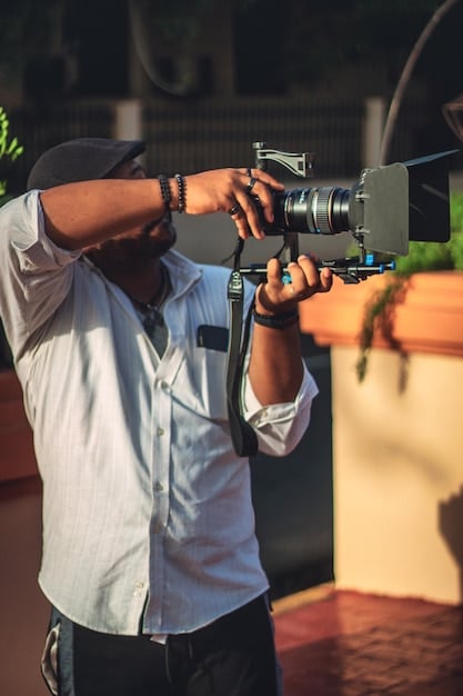 A filmmaker in Nigeria, on location, interviewing a subject for a documentary. The scene should convey a sense of authenticity and engagement.
