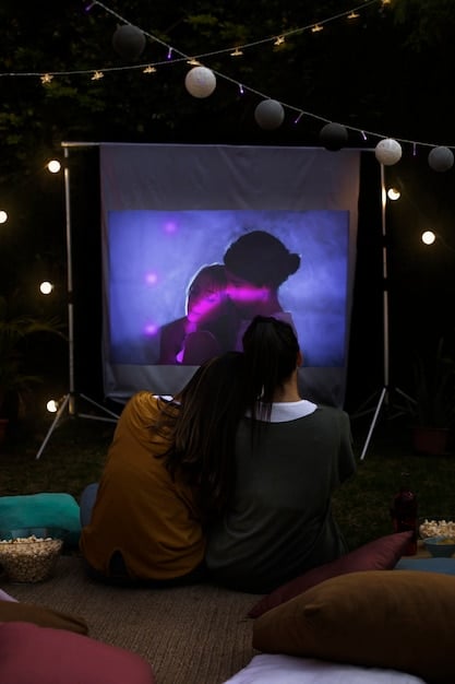 A nighttime scene at ZIFF, showing an outdoor film screening with a large audience. The image should capture the festive atmosphere and the community engagement of the event.